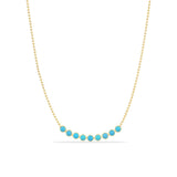 A Birthstone Arc Layering Necklace – Yellow Gold in Turquoise – December on a white background.