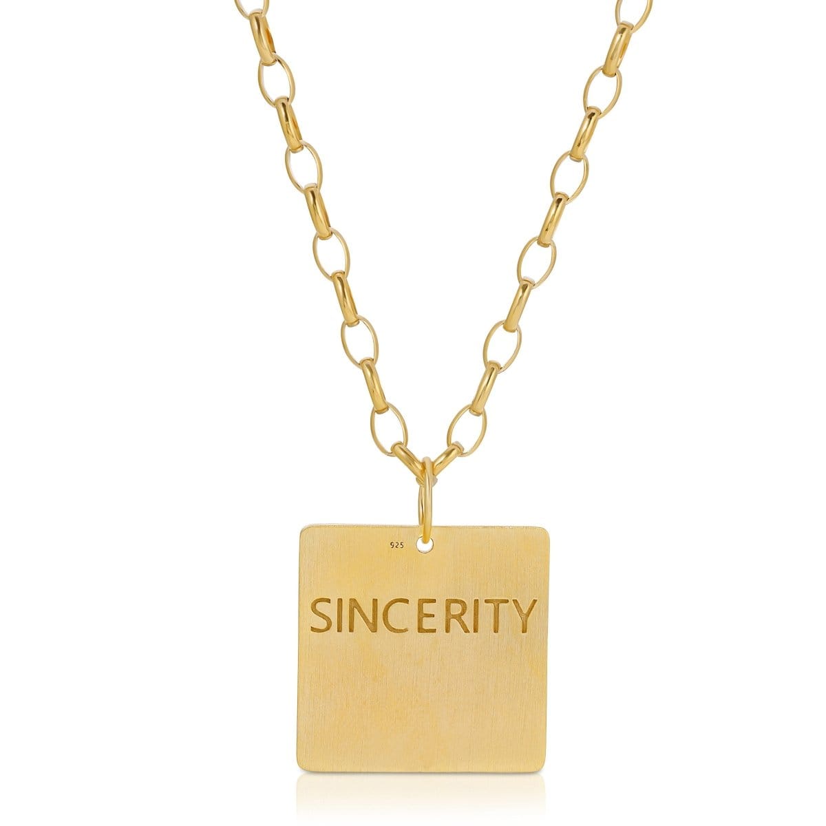 The back of a Virtues Pendant - Square in yellow gold with 'SINCERITY' engraved on a white background. 