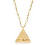 The back of a Virtues Pendant - Triangle in yellow gold with 'COURAGE' engraved on a white background. 