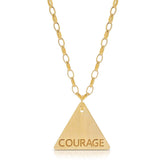 The back of a Virtues Pendant - Triangle in yellow gold with 'COURAGE' engraved on a white background. 