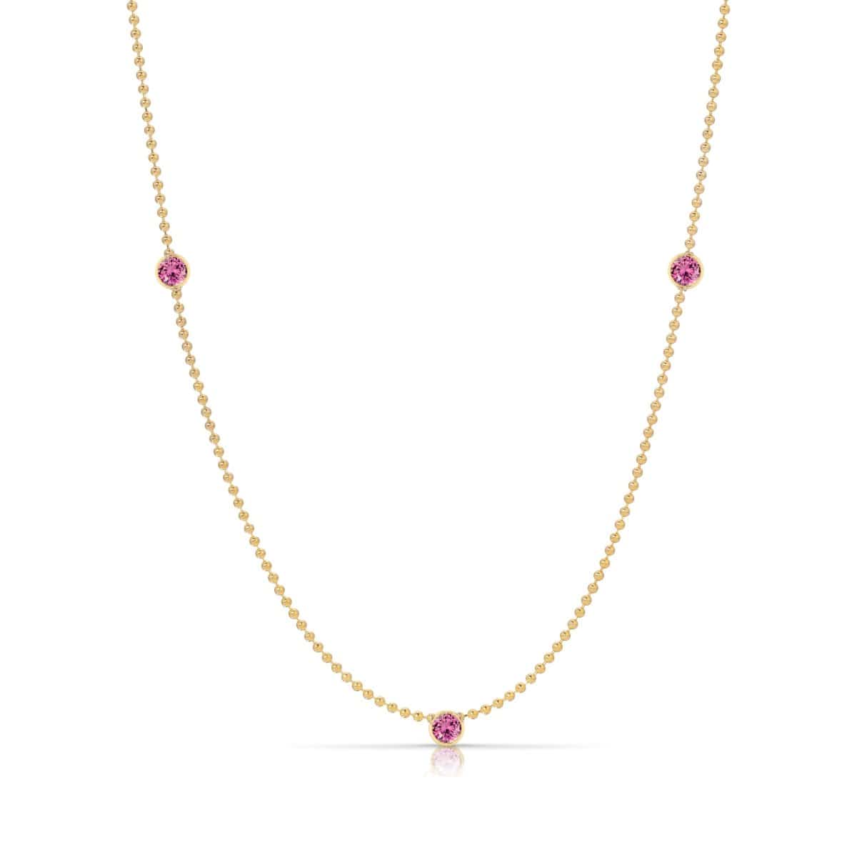 A Triple Birthstone Layering Necklace - Yellow Gold in Pink Tourmaline - October on a white background.