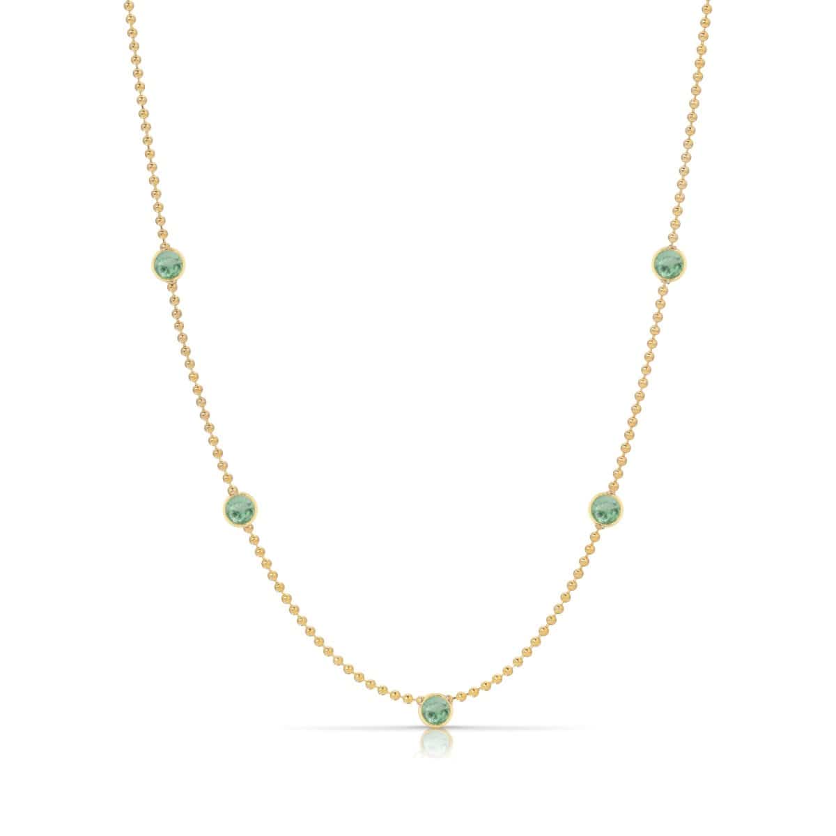 A Quintet Birthstone Layering Necklace - Yellow Gold in Emerald - May on a white background.