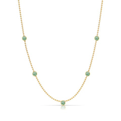 A Quintet Birthstone Layering Necklace - Yellow Gold in Emerald - May on a white background.