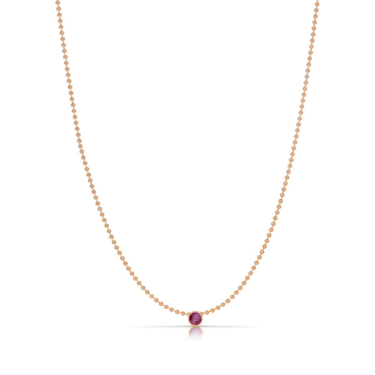 A Single Birthstone Layering Necklace - Rose Gold in Ruby on a white background.