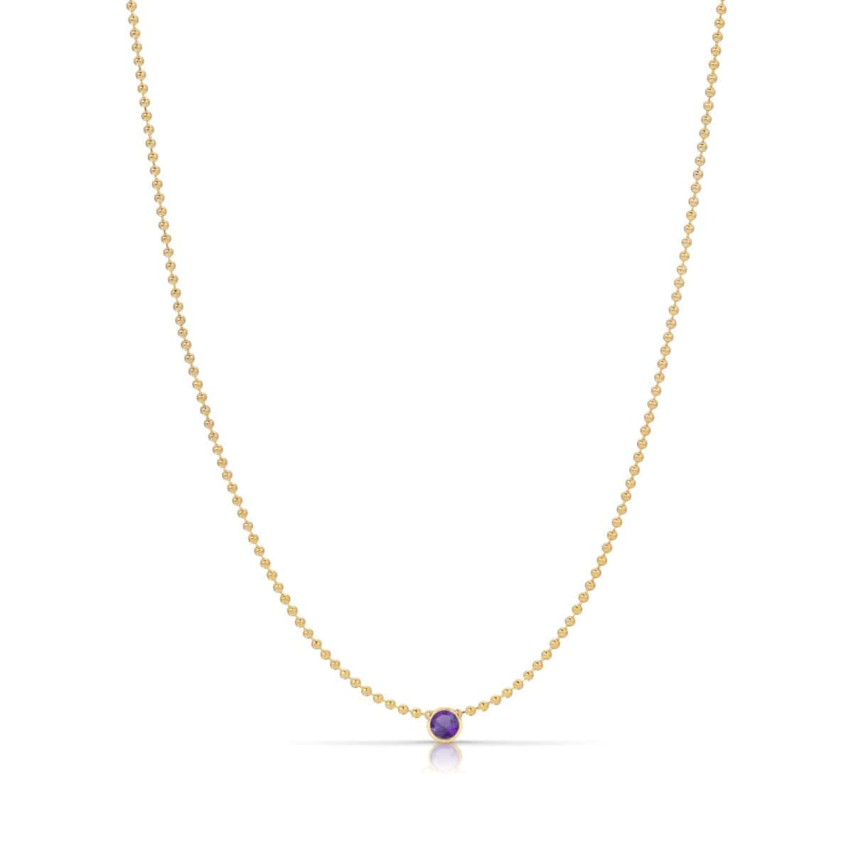 A Single Birthstone Layering Necklace - Yellow Gold in Amethyst - February on a white background.