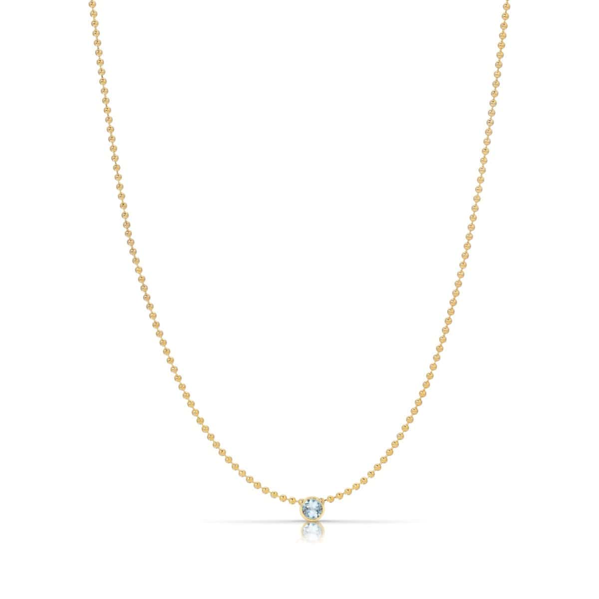 A Single Birthstone Layering Necklace - Yellow Gold in Aquamarine - March on a white background.