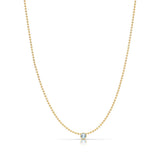A Single Birthstone Layering Necklace - Yellow Gold in Aquamarine - March on a white background.