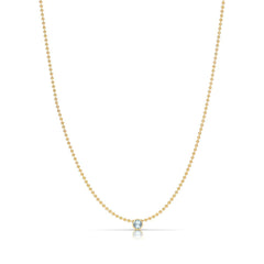 A Single Birthstone Layering Necklace - Yellow Gold in Aquamarine - March on a white background.
