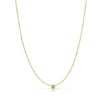 A Single Birthstone Layering Necklace - Yellow Gold in Emerald - May on a white background.