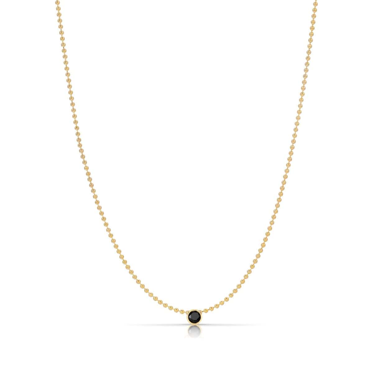 A Single Birthstone Layering Necklace - Yellow Gold in Onyx - August on a white background.