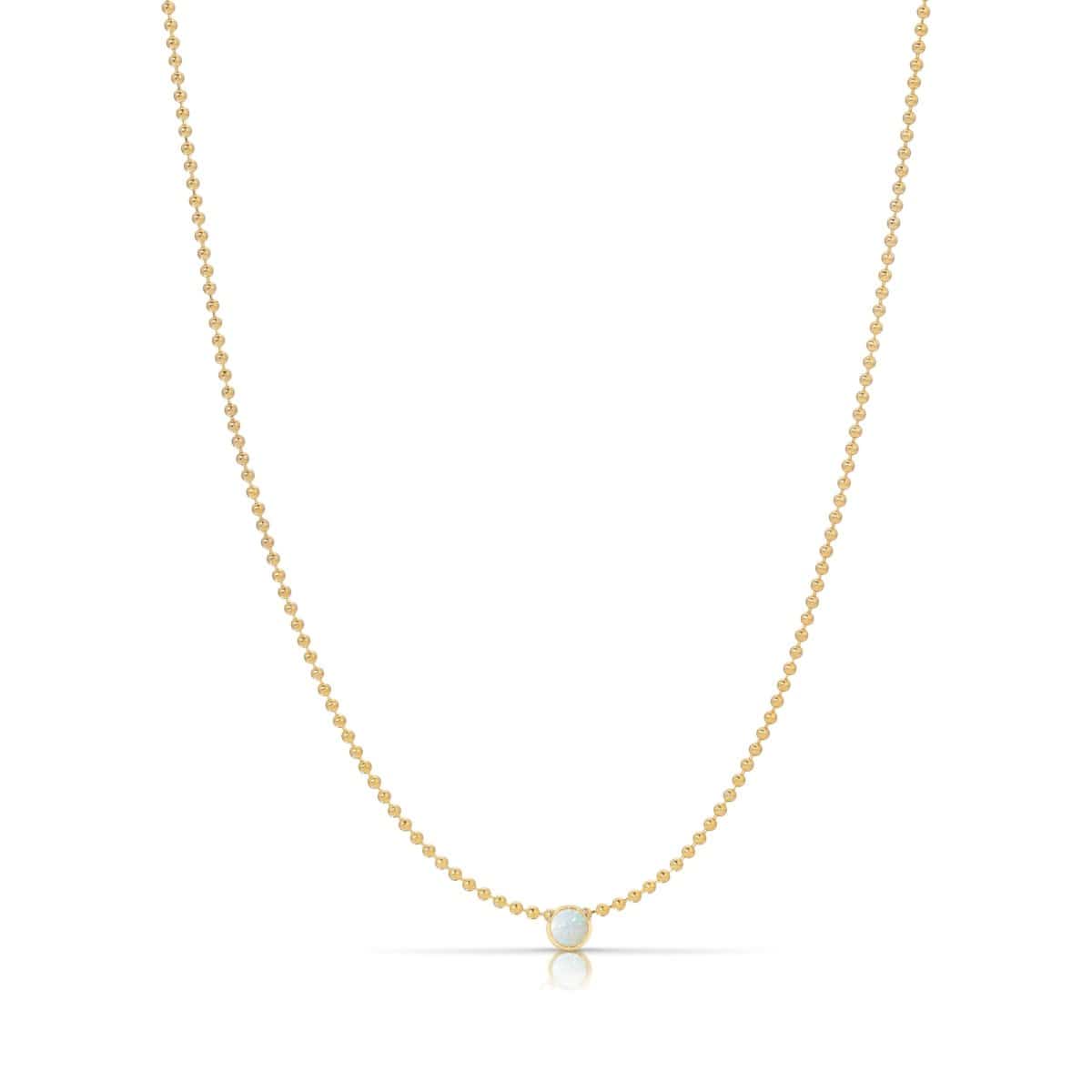A Single Birthstone Layering Necklace - Yellow Gold in Opal - October on a white background. 