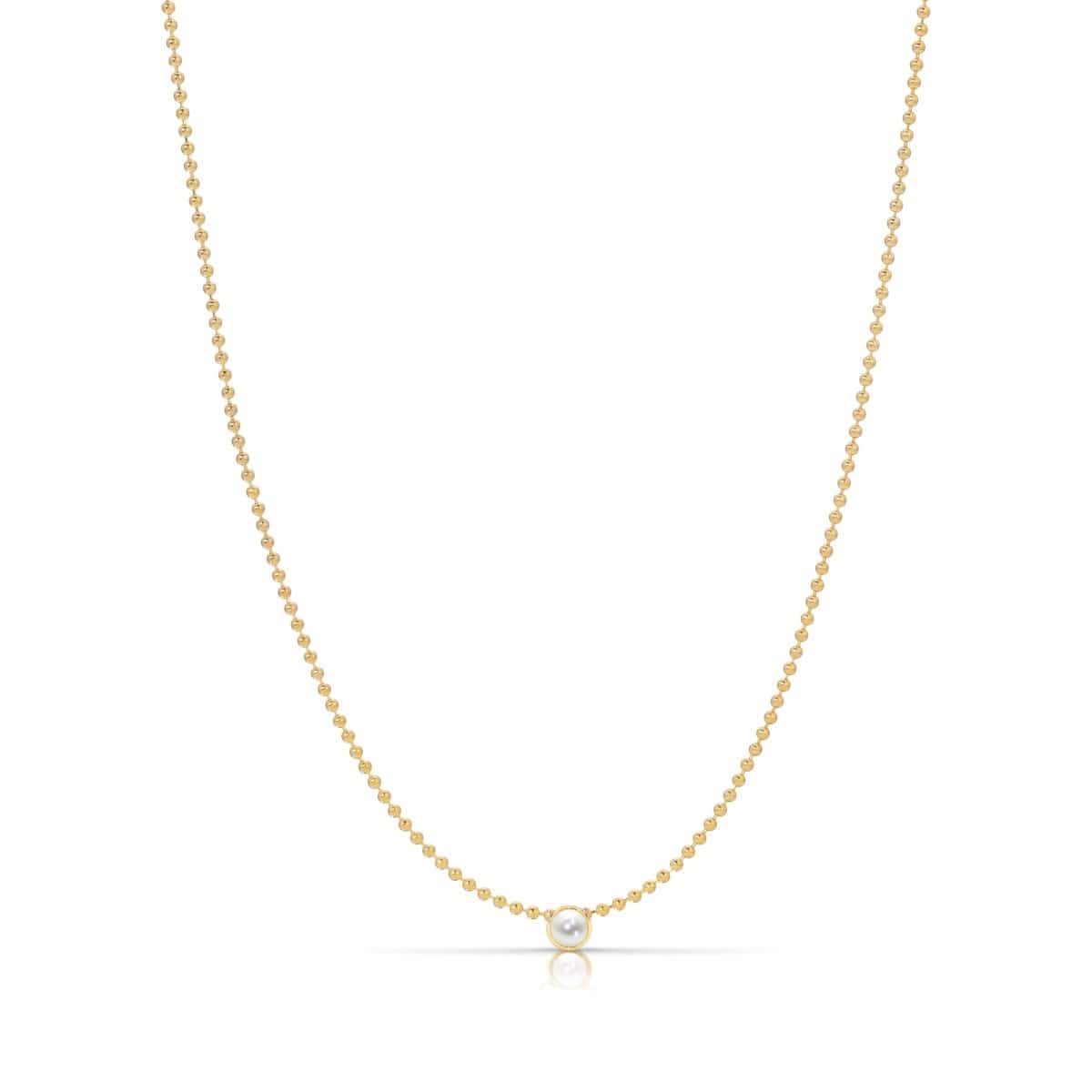 A Single Birthstone Layering Necklace - Yellow Gold in Pearl - June on a white background.