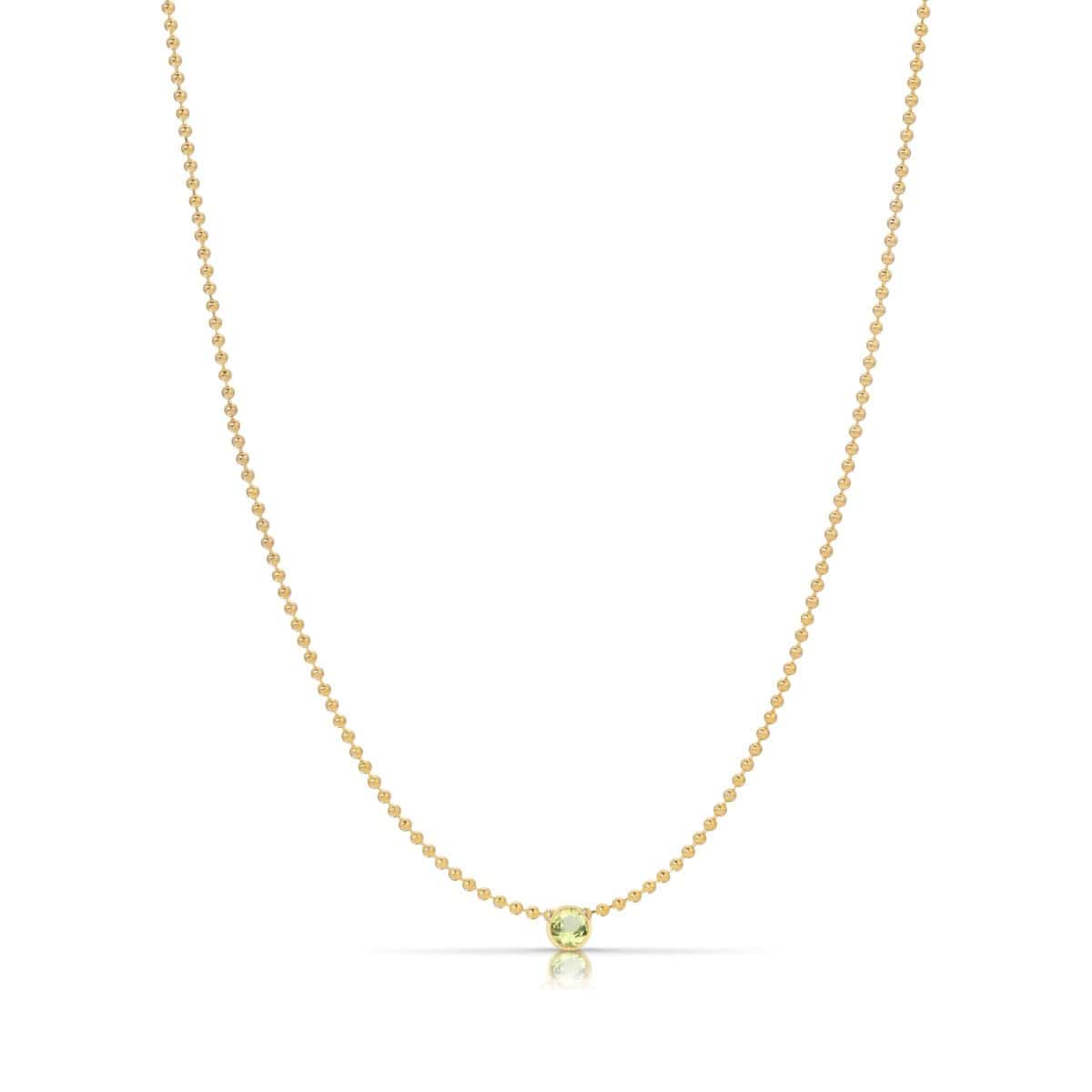 A Single Birthstone Layering Necklace - Yellow Gold in Peridot - August on a white background.