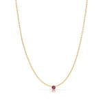 A Single Birthstone Layering Necklace - Yellow Gold in Ruby - July on a white background.