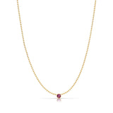 A Single Birthstone Layering Necklace - Yellow Gold in Ruby - July on a white background.