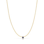 A Single Birthstone Layering Necklace - Yellow Gold in Sapphire - September on a white background.