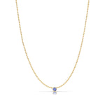 A Single Birthstone Layering Necklace - Yellow Gold in Tanzanite - December on a white background.