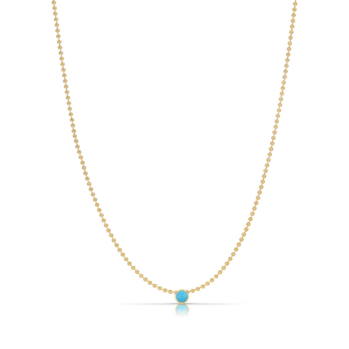 A Single Birthstone Layering Necklace - Yellow Gold in Turquoise - December on a white background.