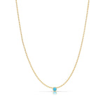 A Single Birthstone Layering Necklace - Yellow Gold in Turquoise - December on a white background.