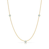 A Triple Birthstone Layering Necklace - Yellow Gold in Aquamarine - March on a white background.