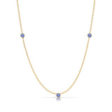 A Triple Birthstone Layering Necklace - Yellow Gold in Tanzanite - December on a white background.