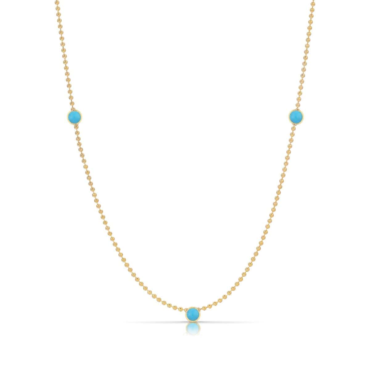 A Triple Birthstone Layering Necklace - Yellow Gold in Turquoise - December on a white background.