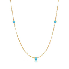 A Triple Birthstone Layering Necklace - Yellow Gold in Turquoise - December on a white background.