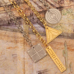 Four Virtues Pendants - Square and Circle in sterling silver, and Rectangle and Triangle in yellow gold vermeil on top of surface with different sketches. 