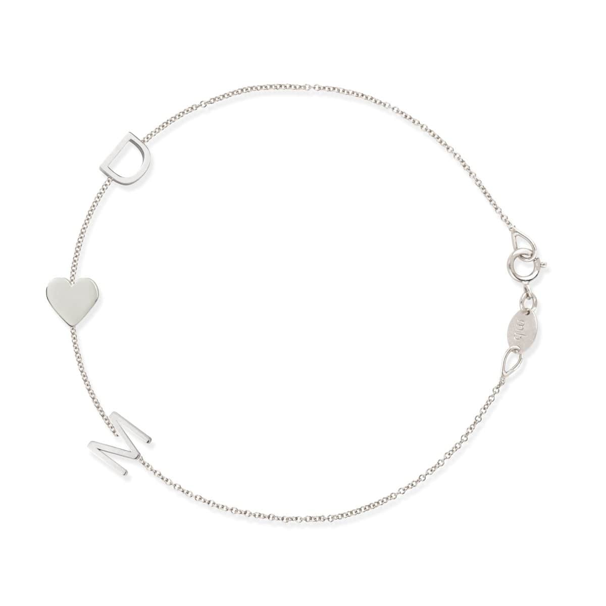 A white gold Custom Gold Bracelet – 3 Letters with the letters D and M and a heart charm, on a white background. 