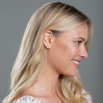 A blonde woman wearing a More Love Stud and Necklace showing her side profile against a grey background. 